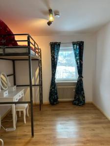 a room with a bunk bed and a window at Stilvolle Familienwohnung in Wörnsmühl in Fischbachau