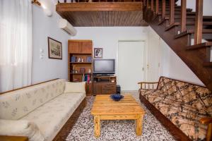 a living room with a couch and a coffee table at Villa Kasta in Kavála