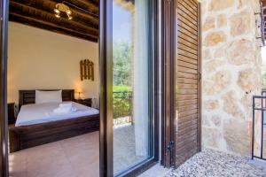 a bedroom with a bed and a sliding glass door at Villa Kasta in Kavála