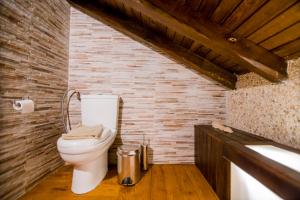 a bathroom with a toilet and a brick wall at Villa Kasta in Kavála +42 photos