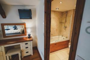 a bathroom with a bed and a tub and a television at Hawley Farm in Hawley Bottom +66 photos