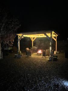 a pavilion with chairs and a fire at night at Loch Ness Pods in Fort Augustus