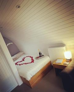 a bedroom with a bed with a heart made out of roses at Loch Ness Pods in Fort Augustus