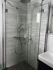 a shower with a glass door in a bathroom at Haus Maensel in Kelberg +9 photos