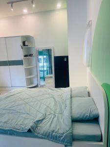 a bedroom with a bed and a book shelf at SNOW HOUSE HCR in Ho Chi Minh City