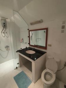 a bathroom with a sink and a toilet and a mirror at like in heaven poolvilla in Pattaya South