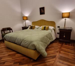a bedroom with a large bed and two lamps on tables at L'Arnia in Naples