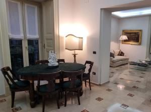 a living room with a table and chairs and a couch at L'Arnia in Naples