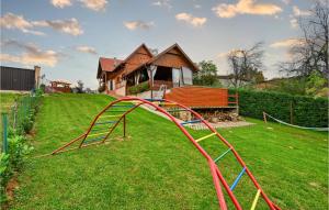 a playground with a slide in a yard at Awesome Home In Velika Buna With Wifi in Velika Buna