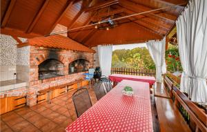 an outdoor patio with a table and a brick oven at Awesome Home In Velika Buna With Wifi in Velika Buna