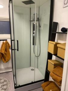 a glass shower in a room with boxes at House with garage in central Lyngen in Lyngseidet +46 photos