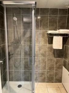 a shower with a glass door in a bathroom at Attrap'Rêves in Aspres-sur-Buëch