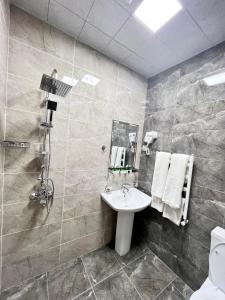 a bathroom with a sink and a shower at Cinema Boutique Hotel in Ganja