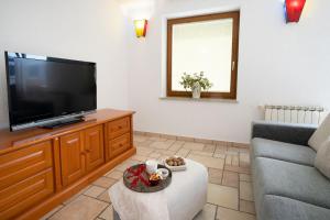 a living room with a flat screen tv and a couch at Apartment Ajdi in Ajdovščina