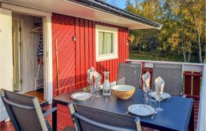a table and chairs on a porch with a table and chairs at Pet Friendly Home In Evje With Wifi in Evje