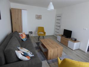 a living room with a couch and a coffee table at Apartmán Dolinky in Vyhne
