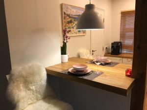 a dining room table with plates and a lamp at Lossi Apartment in Kuressaare