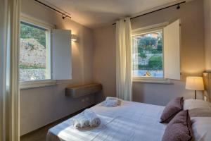 Postel nebo postele na pokoji v ubytování Residence Via Di Francia + 36 fotografií