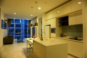 a kitchen with a counter and a table in it at La Platinum KLCC in Kuala Lumpur