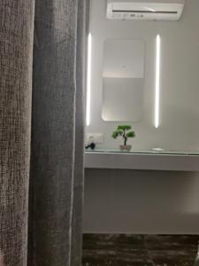 a bathroom with a sink and a plant in a room at Chalkida Hilltop Apartments in Chalkida