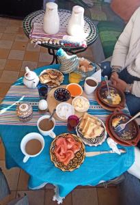 a table full of food on a blue table cloth at Dar El Fanne in Chefchaouene