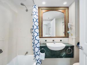 a bathroom with a sink and a mirror at LEGENDS HOTEL - hosted by Coastal Letting in Gold Coast