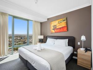 a bedroom with a large bed with a large window at LEGENDS HOTEL - hosted by Coastal Letting in Gold Coast