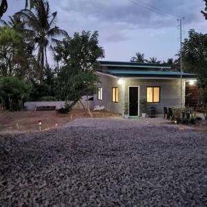 a small white house with a driveway in front of it at King Arts Bed and Breakfast with WiFi and Netflix! Near Bluemoon and Angelfields in Silang