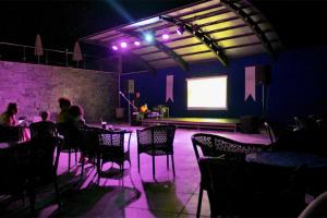a group of people sitting in a room with purple lights at Turunc Premium Hotel in Turunç +240 photos