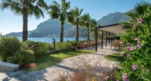 a pavilion with palm trees and a beach at Turunc Premium Hotel in Turunç