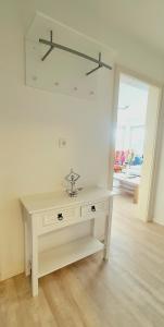 a white table in a room with a mirror at Sanosueno 3 in Sonthofen