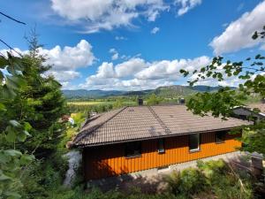 an orange house with a roof on a hill at In Love With Norway in Larvik