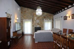 a bedroom with a bed and a fireplace at Villa María Lagos del Serrano in Seville +20 photos