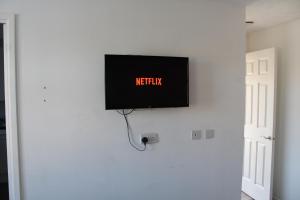 En TV eller et underholdningssystem på Modern studio apartment with parking