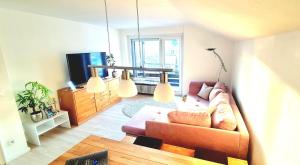 a living room with a couch and a tv at Sanosueno 2 in Sonthofen