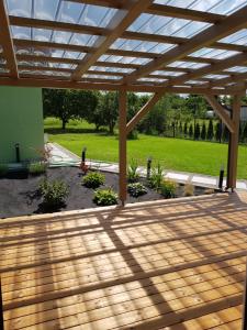a wooden deck with a pergola in a yard at Holiday Home Znojmo w/ Wellness & Wine in Znojmo