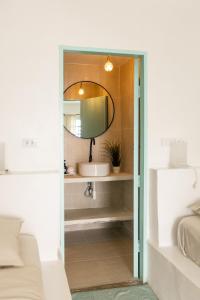 a bathroom with a sink and a mirror at Indie Beach Bungalows in Ko Chang