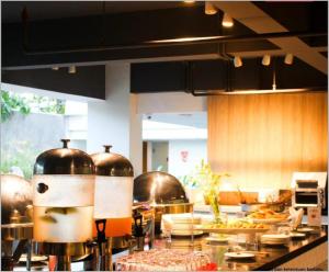 a kitchen with a counter with dishes and a coffee maker at Zuri Express Jimbaran in Jimbaran