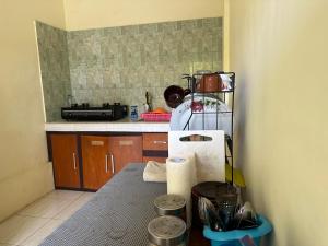 a kitchen with a counter and a counter top with a counter top at Canggu HBD in Canggu
