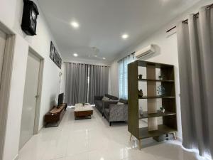 a living room with a couch and a table at RB HOMESTAY in Merlimau