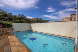 a swimming pool on the roof of a building at Cordilheira Hotel in Serra Negra