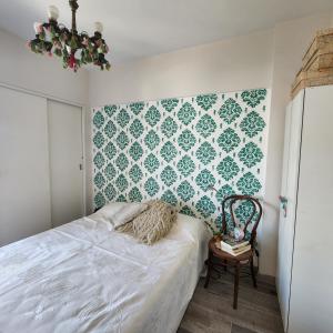 1 dormitorio con 1 cama y una pared verde y blanca en Alquiler temporario en Villa Urquiza en Buenos Aires