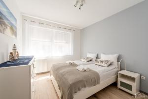 Posteľ alebo postele v izbe v ubytovaní Horyzont Apartamenty - Kapitański Mostek- BLISKO PORTU- Śniadania