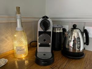 a kitchen counter with a blender and a bottle of wine at Poachers Hut at Keepers Cottage - Hot Tub & Pizza Oven - Trossachs in Port of Menteith