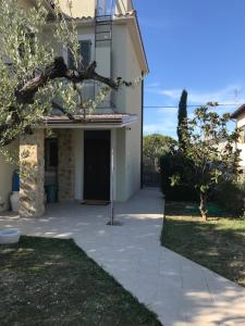 a house with a walkway leading to a driveway at Colombella Apartment Agriturismo Collerisana in Spoleto