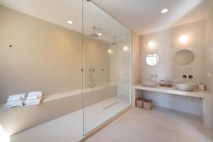 a bathroom with a glass shower and two sinks at B&B Antico Ulivo in Monopoli