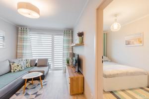 Posteľ alebo postele v izbe v ubytovaní Horyzont Apartamenty - Osiedle Bursztynowe