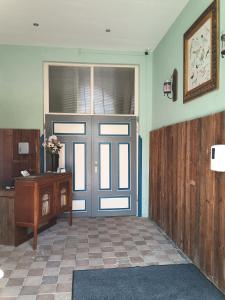 a door in a room with a table and a desk at zur Friedrichsruh in Oelsnitz