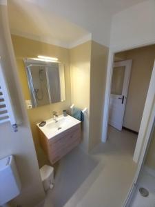 ein Badezimmer mit einem Waschbecken, einem WC und einem Spiegel in der Unterkunft Appartamento Sophie LT in Santa Maria Maggiore