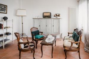 a living room with chairs and a tv on a cabinet at Locanda Mescoglia in Corciano